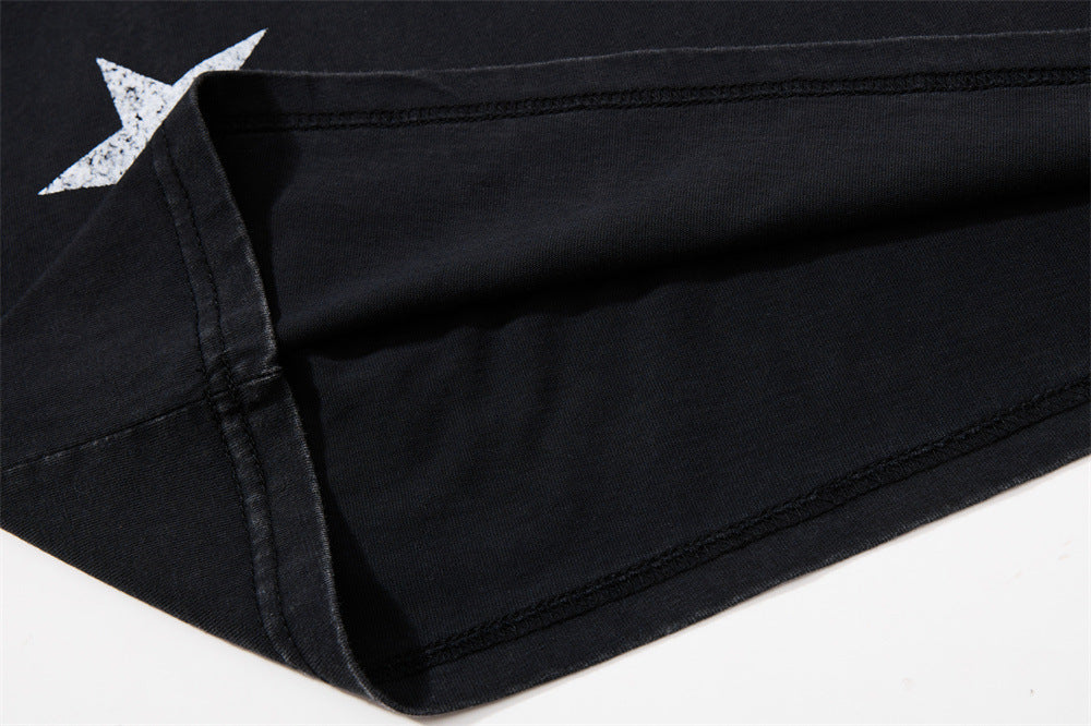 Close-up of side seam and stitched hem on black knit tee with star print