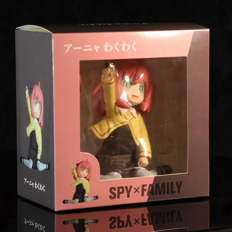 Explore the Anya Forger figure from &quot;Spy × Family,&quot; featuring her in a yellow school uniform with interchangeable face. This vibrant collectible comes seated in a display box with Japanese text, making it an ideal addition for any anime fan&