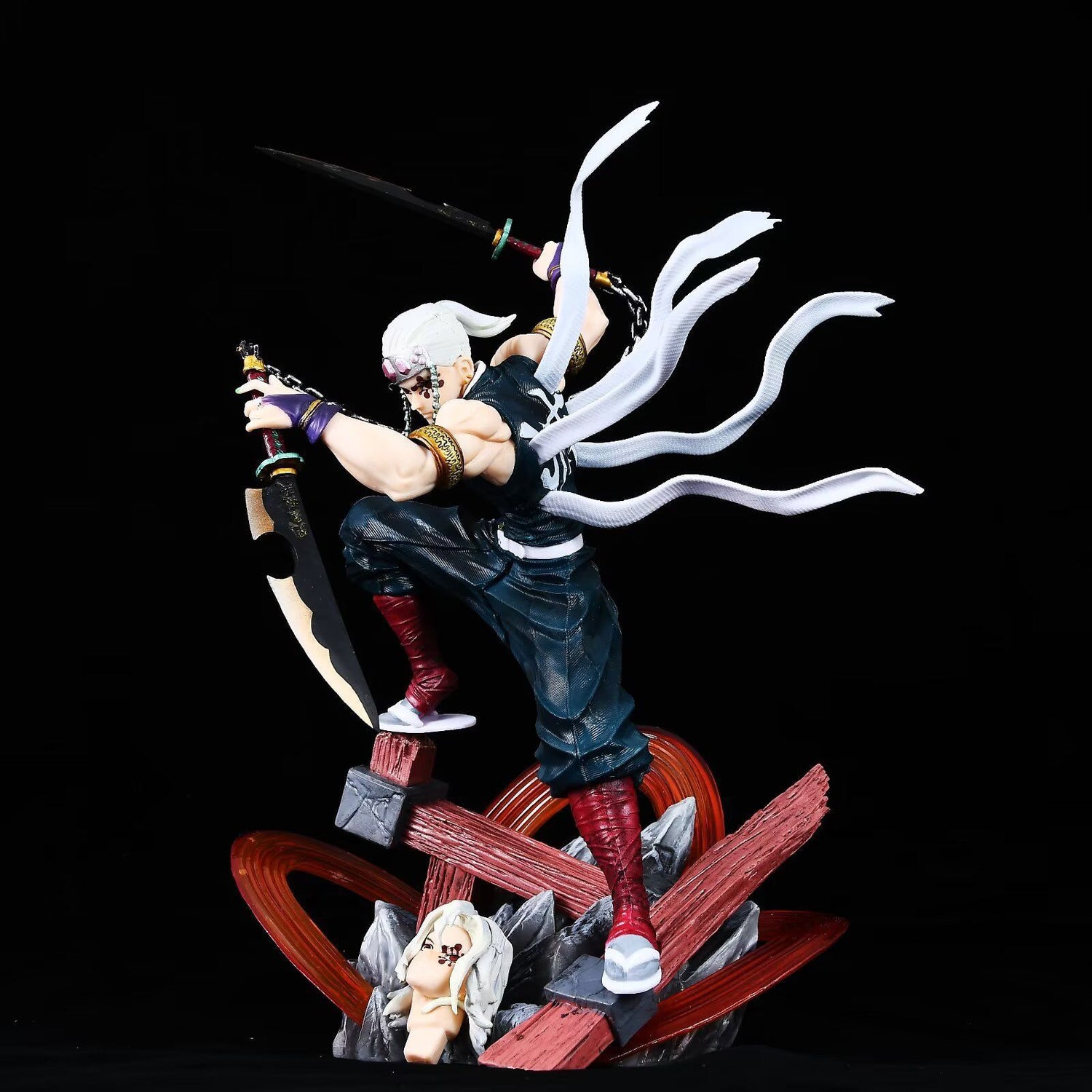 The Tengen Uzui Battle Sound Pillar Figure, a 27cm GK model from Demon Slayer, showcases a dynamic pose with white hair and masked face. The PVC collectible features a sword-wielding stance on one knee with dark attire and red boots, capturing the essence of the Sound Hashira against a black background.