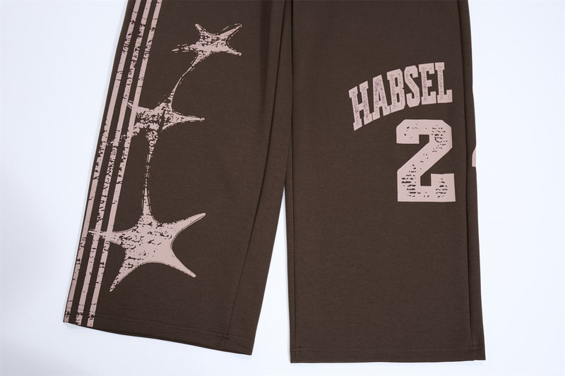 Pantalones de chándal de pierna ancha con estampado gráfico varsity y cintura rosa en contraste