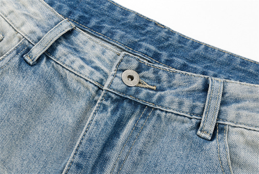 Close-up of denim waistband with button closure and belt loops