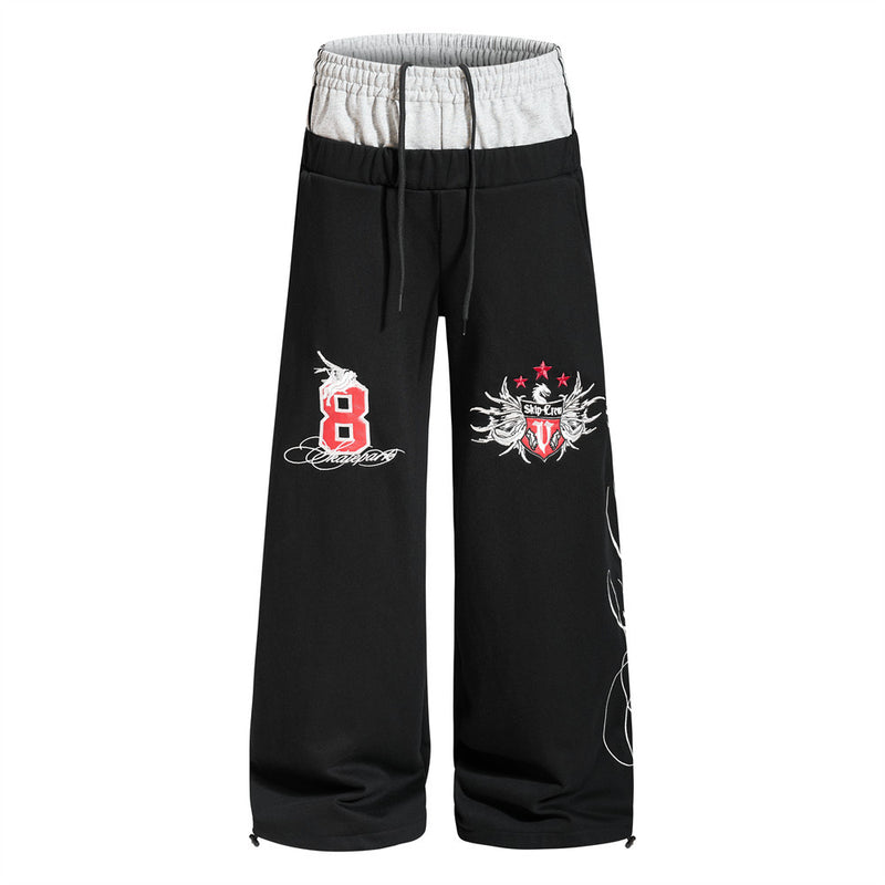 Men's black colorblock double waistband wide-leg sweatpants with embroidered number 8 crest and script graphic detail