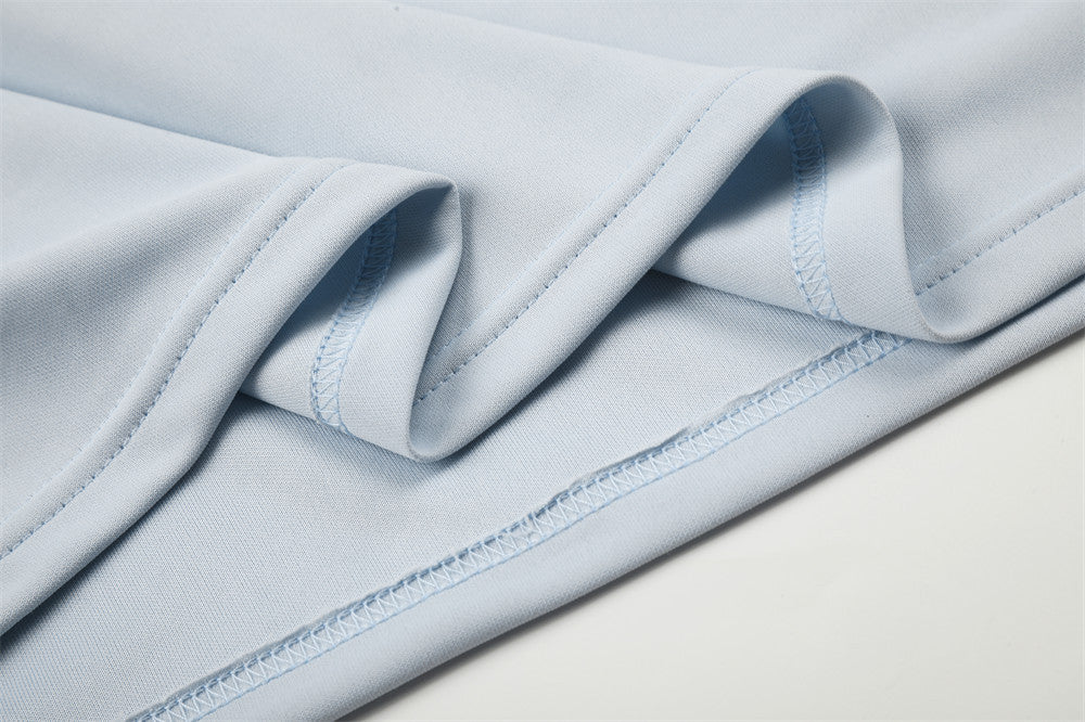 Close-up of light blue sleeve and hem stitching