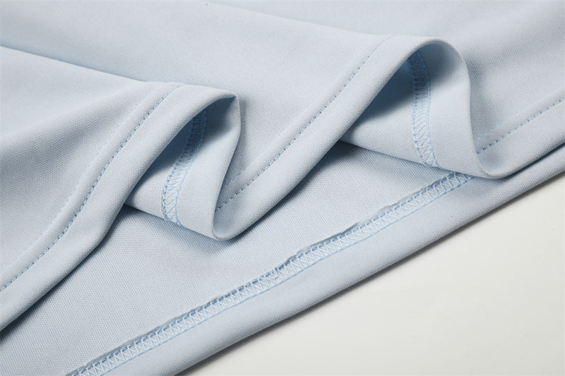 Close-up of light blue sleeve and hem stitching