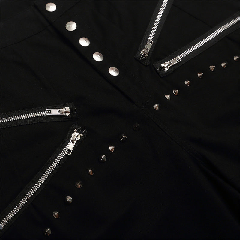 Close-up of black shorts front with diagonal zippers and silver studs