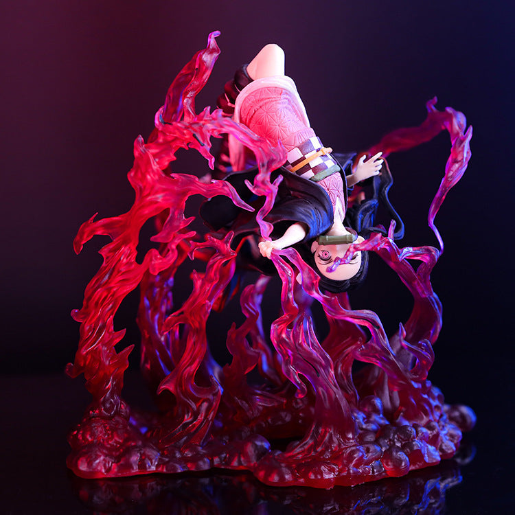 Discover the stunning Demon Slayer Figure - Nezuko Explosion Pose. This premium action figure features an upside-down pose, long black hair amidst swirling red flames, a pink outfit with a belt, and dramatic contrast against a dark backdrop.