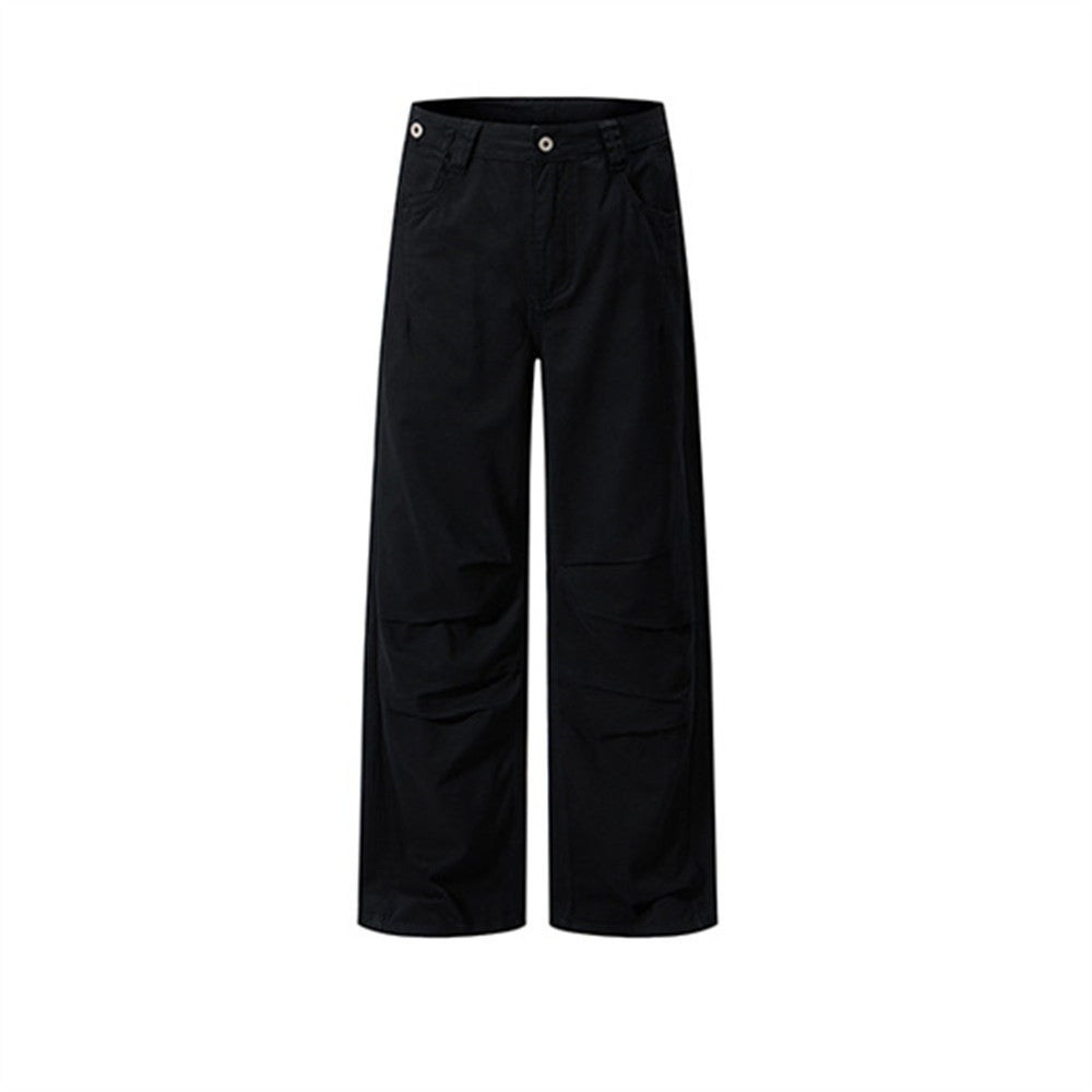 Men's baggy wide-leg pleated cargo trousers in black, front view showing gathered thigh panels and straight hem