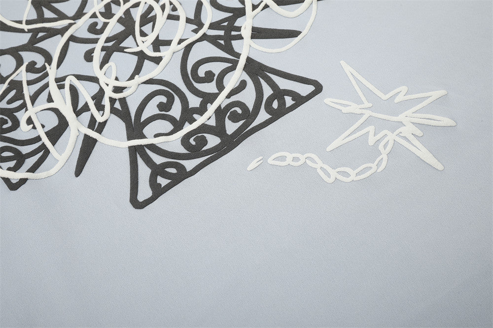 Close-up of star detail and graphic print on light blue long sleeve tee