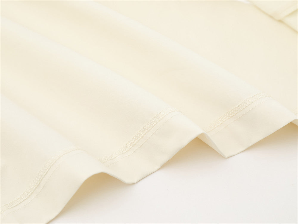 Close-up of cream shirt bottom hem stitching