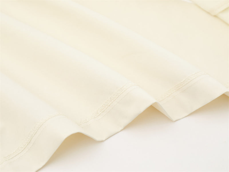 Close-up of cream shirt bottom hem stitching