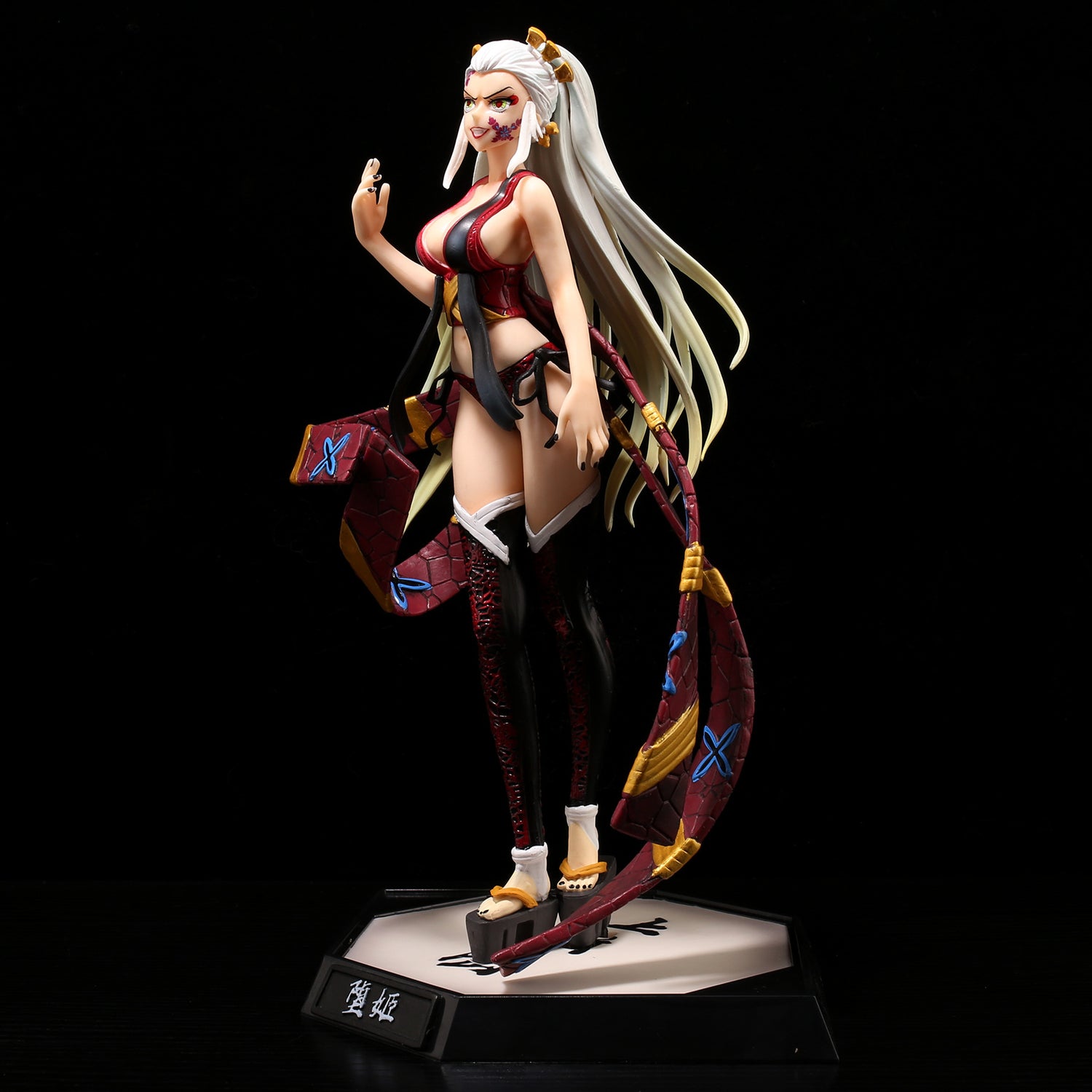 The Daki Demon Slayer Figure, a 28CM PVC action figure by Demon Slayer, embodies the elegance of Upper Rank demons with her long white hair, red and black outfit, patterned sash, and poised hand on a hexagonal base featuring Japanese text.