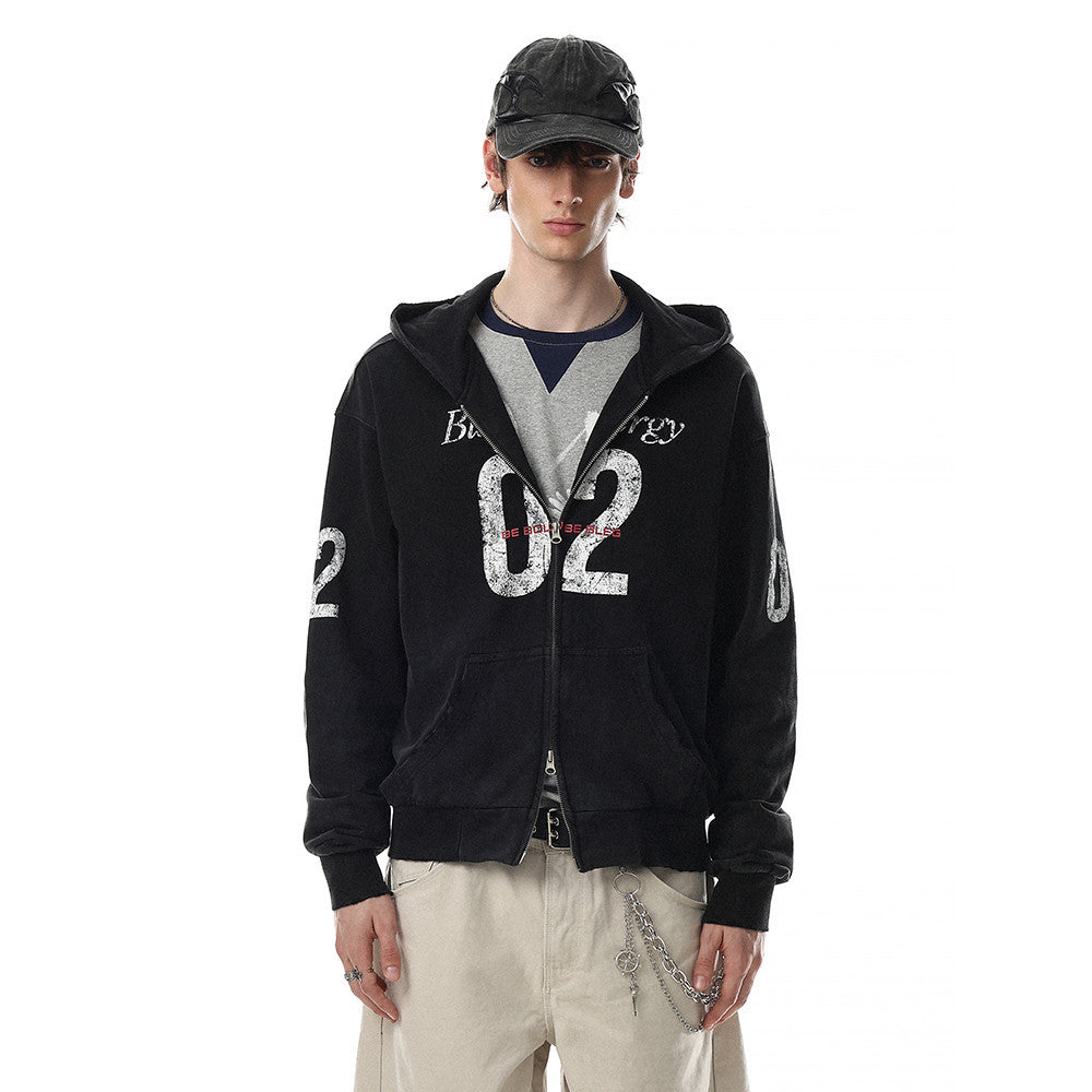 Model wearing black zip-up hoodie with '02' graphic, front view