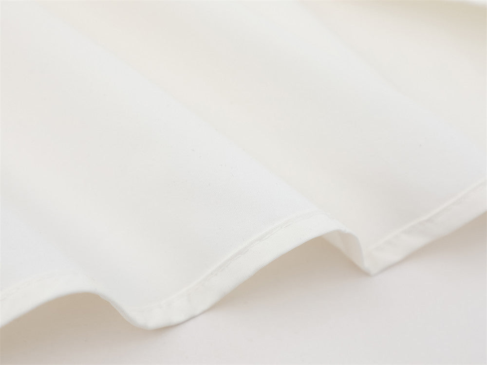 Close-up of white shirt curved hem and side seam