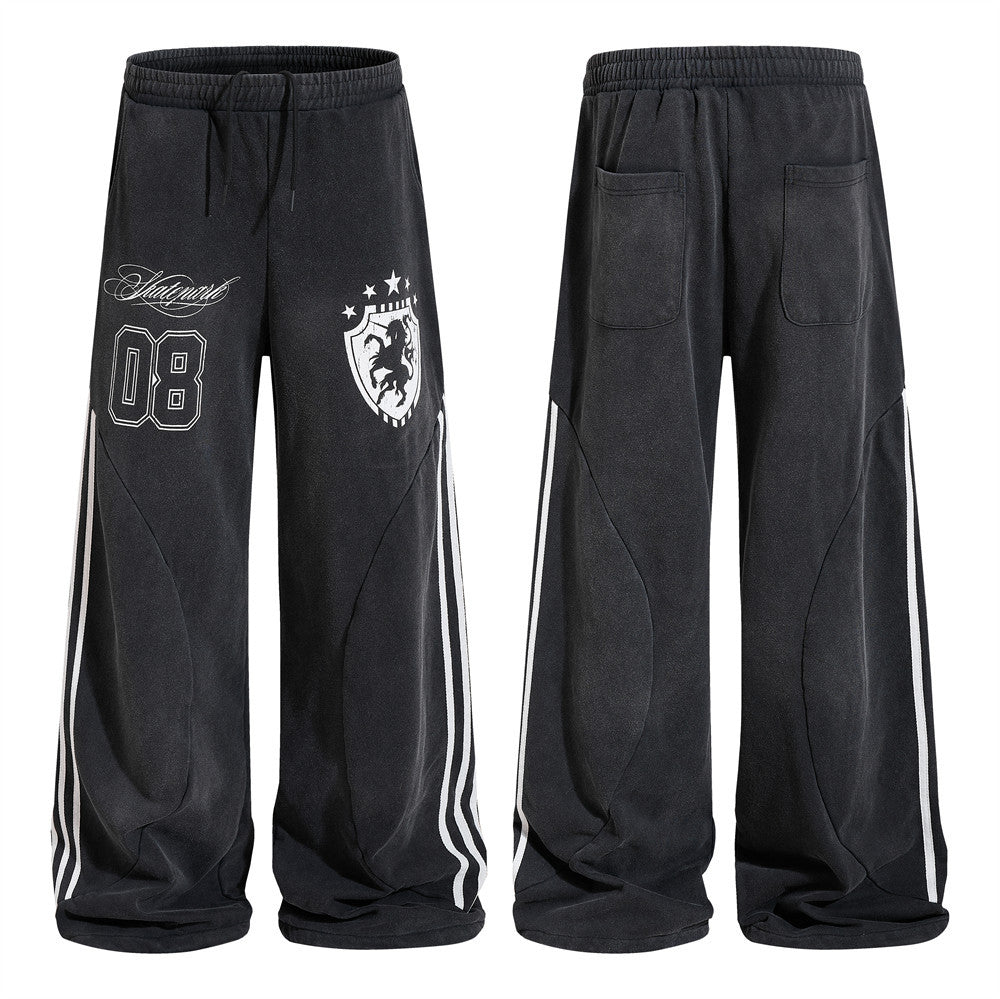 Black baggy wide-leg sweatpants with varsity 08 graphic, heraldic crest print, and white triple side stripes, front and back