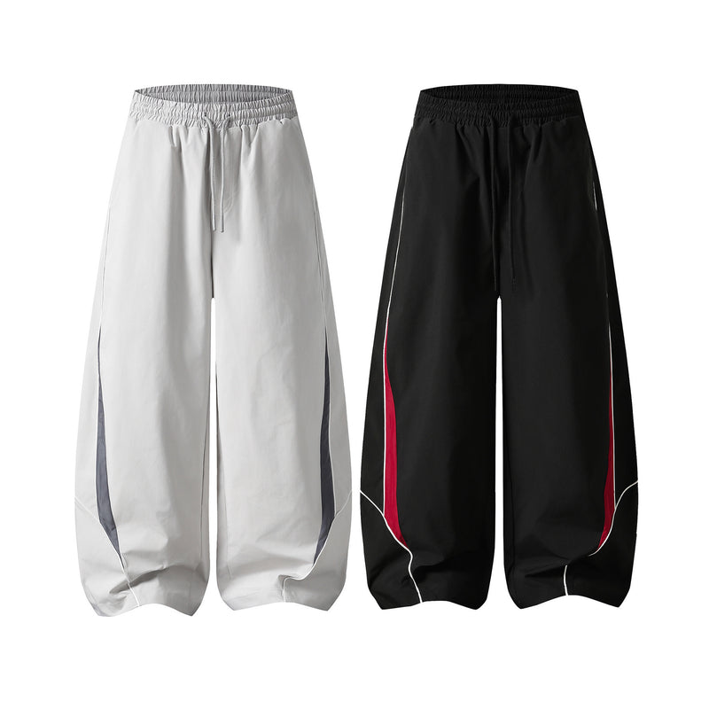 Herren-Trackpants mit kontrastierender Paspel und Colorblock-Seiteneinsätzen