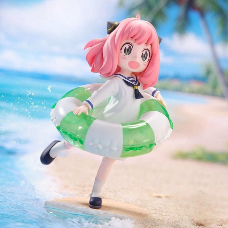 This 10cm PVC anime collectible features Anya Forger with pink hair, dressed in a sailor outfit. She stands on a beach with a green and white inflatable ring amid blue sea waves and palm trees under a clear sky—a must-have for Spy × Family fans.