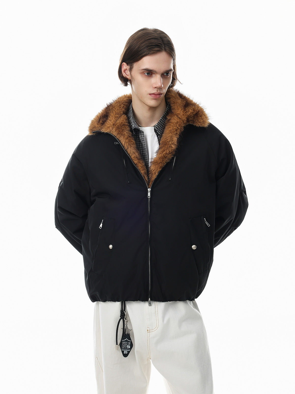 Oversized black padded bomber jacket with caramel faux fur collar, zip pockets and elasticated hem, worn by male model