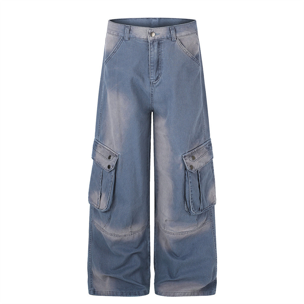 Wide-leg washed denim cargo pants with multi snap-button thigh pockets in faded blue, front view