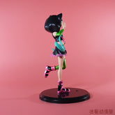 A side view of the Hatsune Miku Cat Hoodie 17cm PVC Figure, a cute and stylish Vocaloid collectible, is shown on a black stand against a pink background. The figure features short hair, a green glove, black top, pink boots, and strikes a dynamic pose with one leg raised.