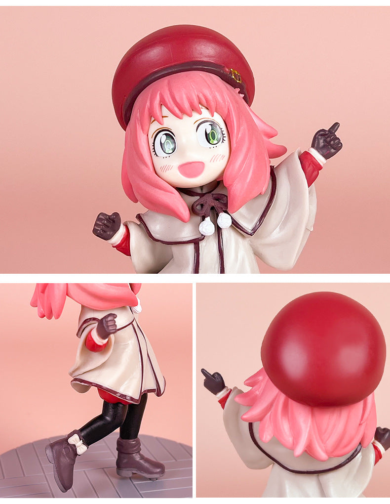 The Spy x Family Detective Anya PVC Figure Set – 14 cm, Movie Version, by Spy × Family, features a pink-haired character in a red hat and white coat with black leggings and brown boots. The figure includes 4 dynamic poses showing her excitedly with arms outstretched.