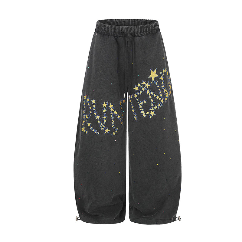 Pantalon de survêtement délavé à jambes larges avec imprimé de constellation d'étoiles jaunes et points façon éclaboussures de peinture, en noir