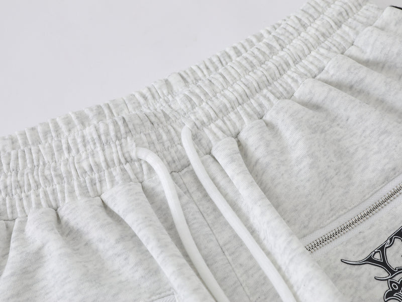 Pantalon de survêtement à jambes larges avec graphisme héraldique et détails latéraux multibandes