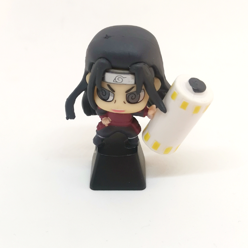 A chibi-style Naruto figurine with long black hair, a headband, and red outfit holds a yellow-accented cylinder. Ideal for fans of the &quot;Ninja Masters Keycap Set – Naruto Characters&quot; by Naruto. It stands on a black base against a white background.