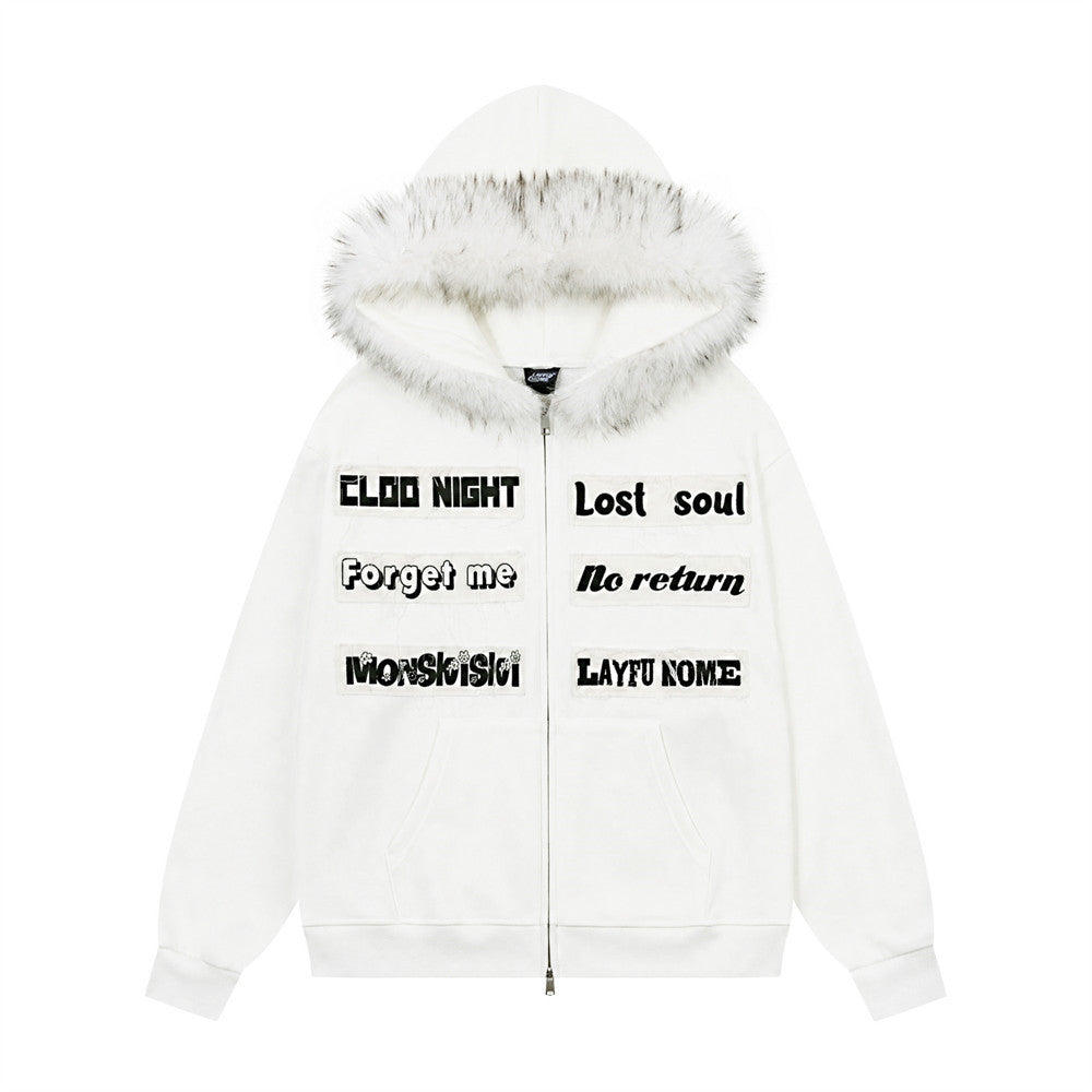 Oversized zip-up hoodie with faux-fur trim hood and letter patch appliqués in white, front view