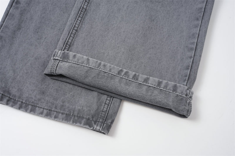 Cuffed hem detail on washed grey straight-leg jeans