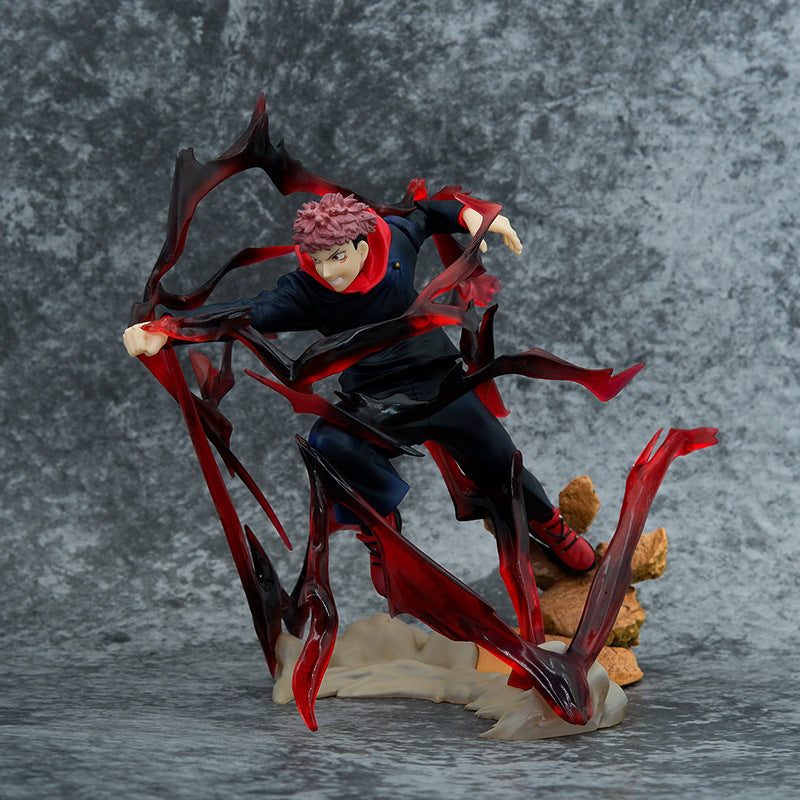 The Jujutsu Kaisen Yuji Itadori PVC Figure (18 cm) features his iconic spiky red-pink hair, dark blue outfit with red shoes, and a dynamic pose capturing a swirling red and black cursed energy effect against a gray marbled backdrop.