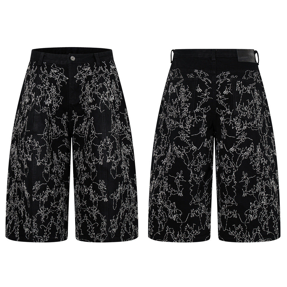 Black wide-leg denim shorts with all-over white chaotic stitch embroidery, front and back view