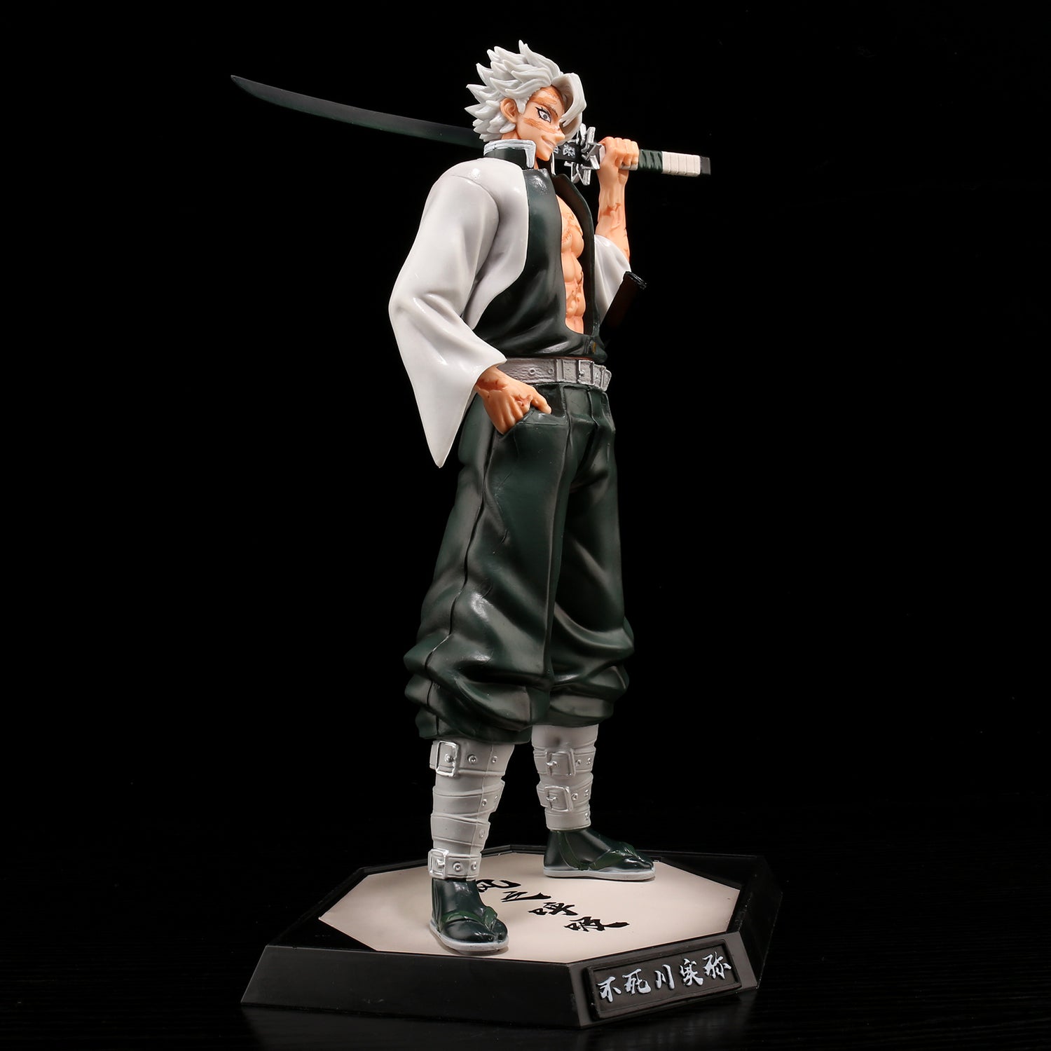 The Shinjuro Rengoku Demon Slayer PVC Figure is a 29cm high-quality collectible featuring a spiky gray-haired character in a white and black outfit, holding a sword on their shoulder. The square base has Japanese text on a black background.