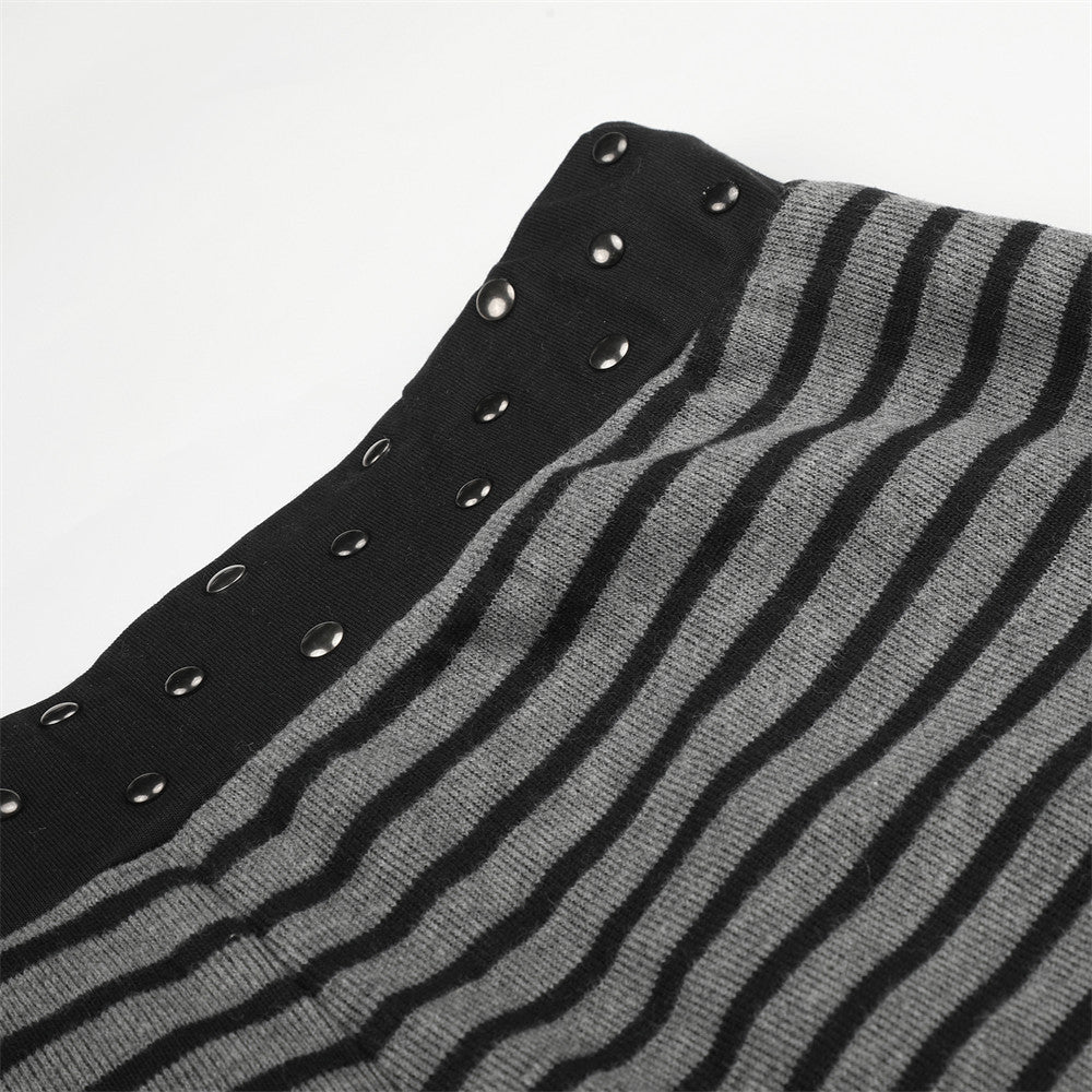 Black studded waistband on gray and black striped pants, close-up detail