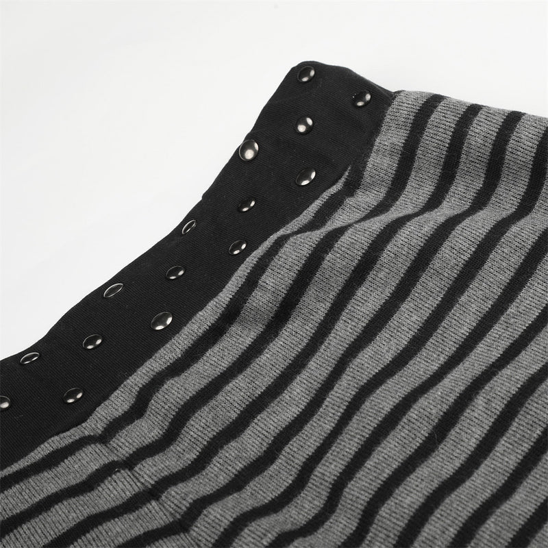 Black studded waistband on gray and black striped pants, close-up detail