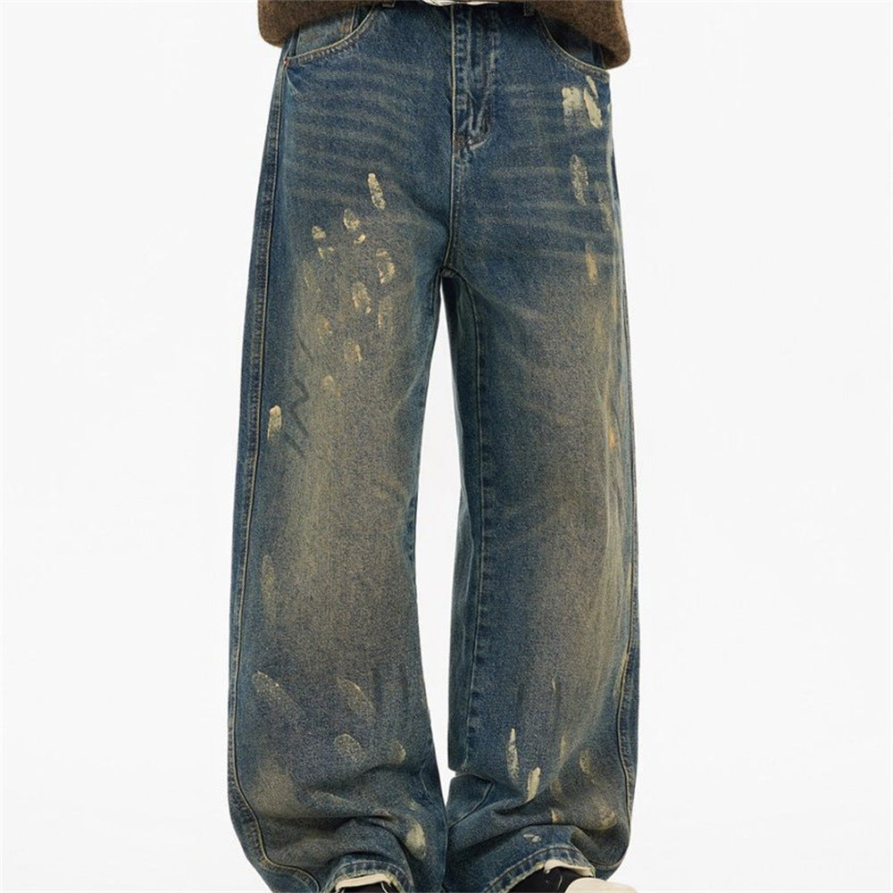 Men's baggy distressed vintage wash straight-leg jeans in nostalgic blue with heavy rips and golden mud-tone fading