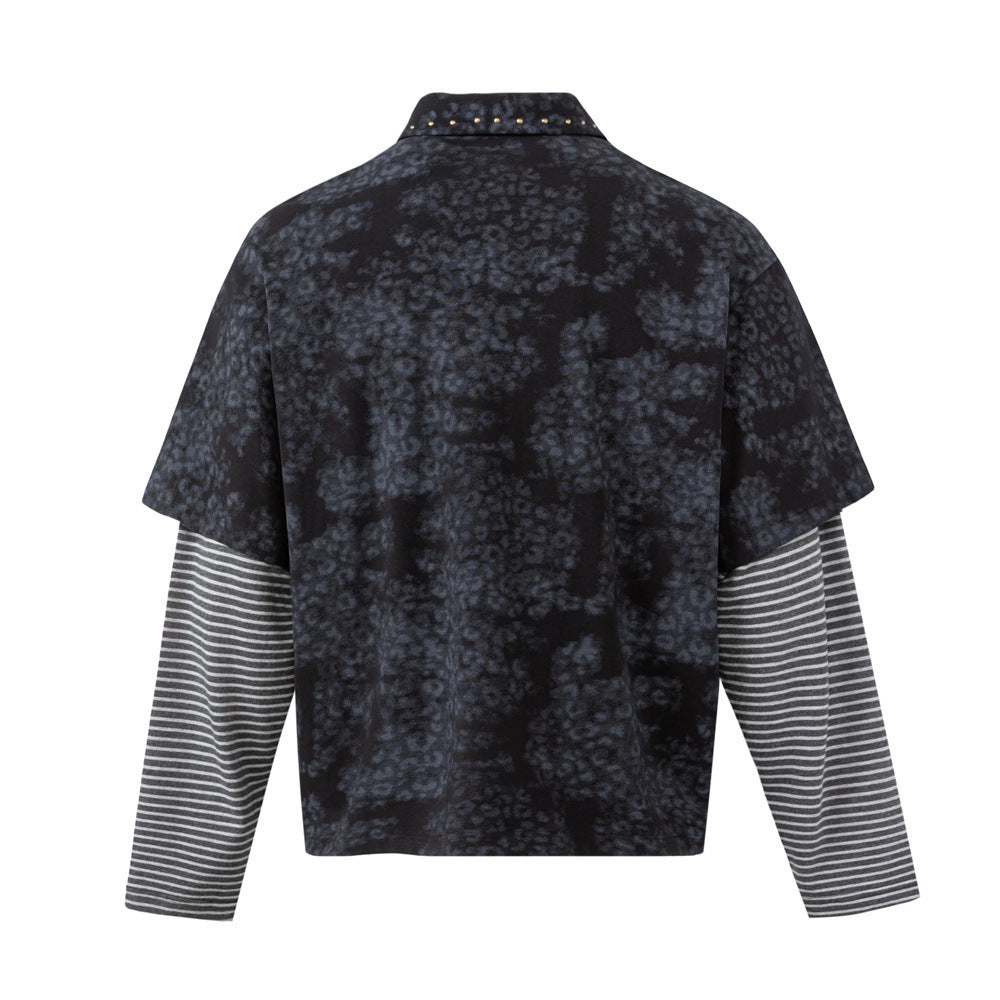 Back view of a dark mottled faux-layered polo shirt with contrasting striped sleeves and studded collar