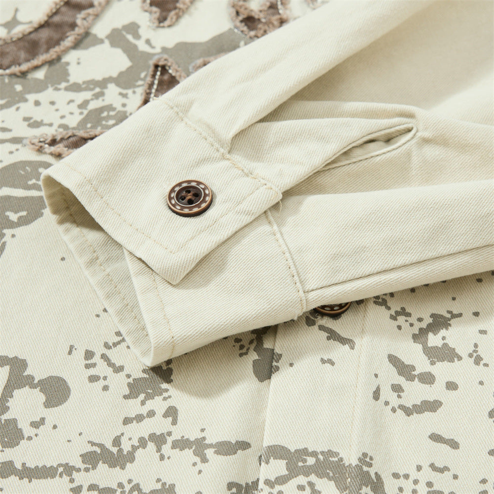 Rolled sleeve cuff on cream shirt with brown button detail