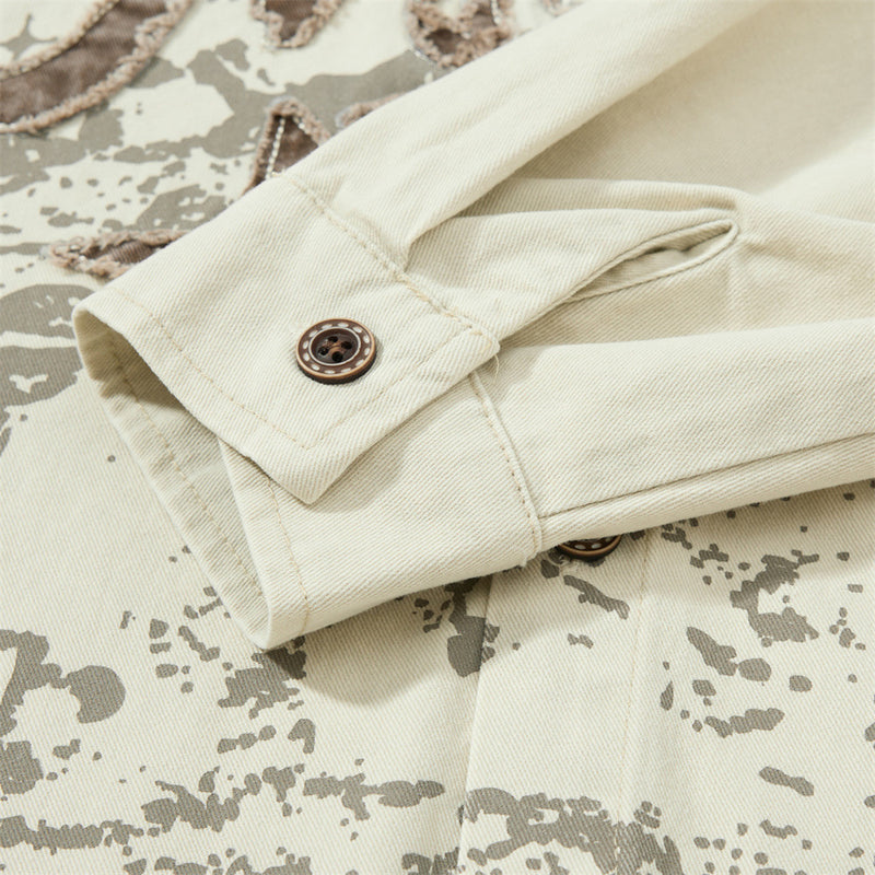 Rolled sleeve cuff on cream shirt with brown button detail