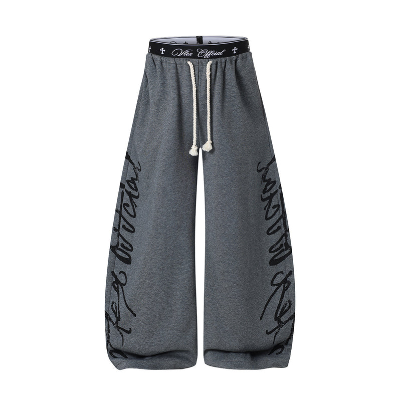 Pantalon de survêtement à jambes larges avec imprimé graffiti cursif et ceinture élastiquée siglée