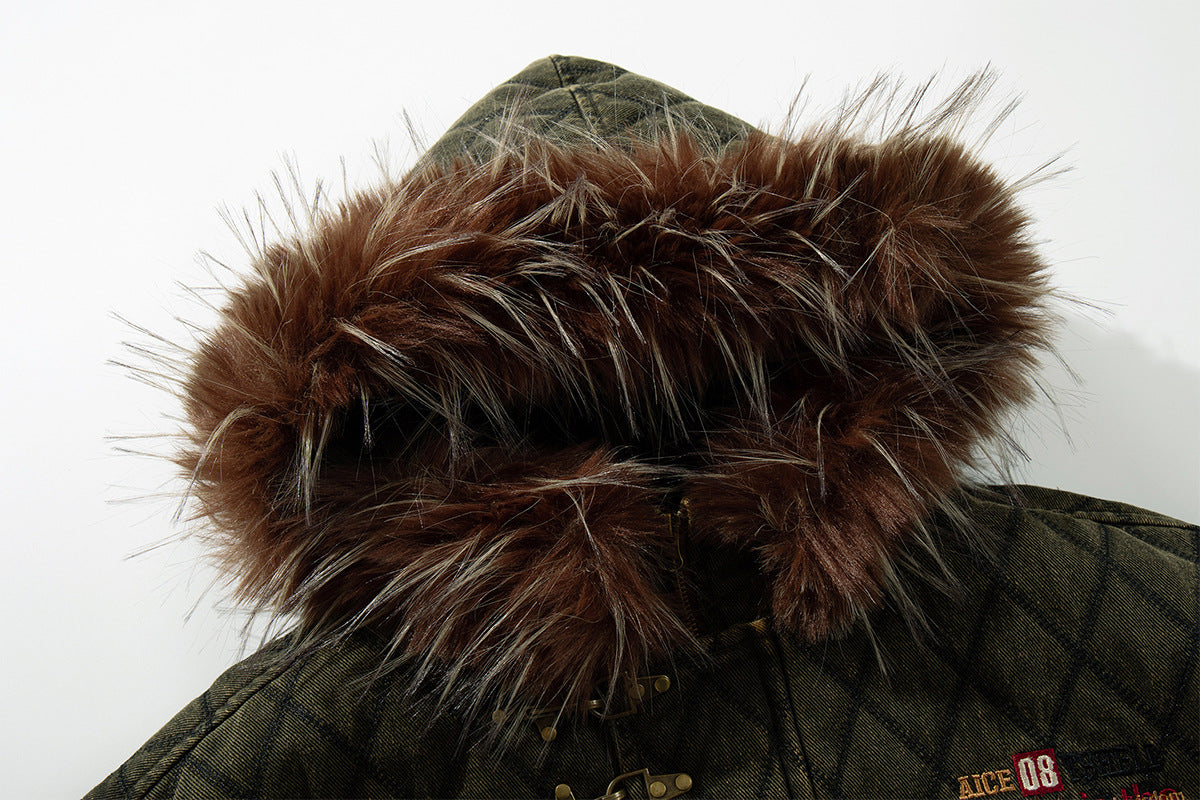 Close-up of the brown fur-trimmed hood on an olive green quilted diamond jacket