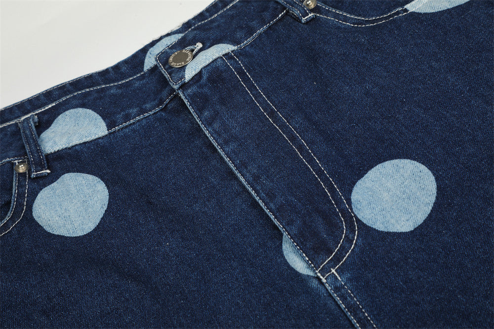 Close-up of waistband and front pocket on dark blue polka dot jeans