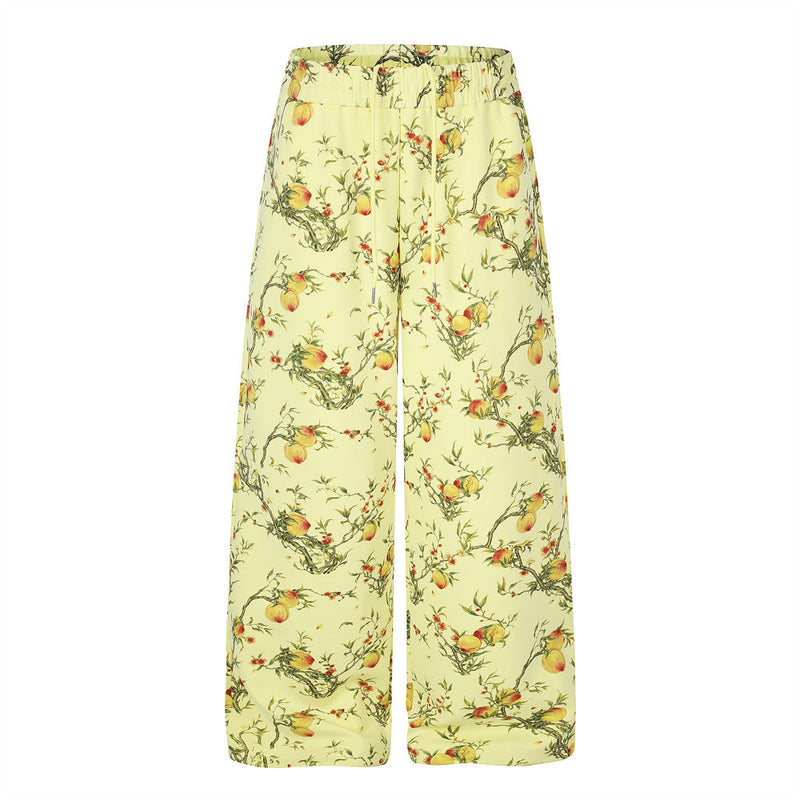 Wide-leg pants in pale yellow with all-over peach blossom and fruit branch botanical print, elasticated drawstring waistband,