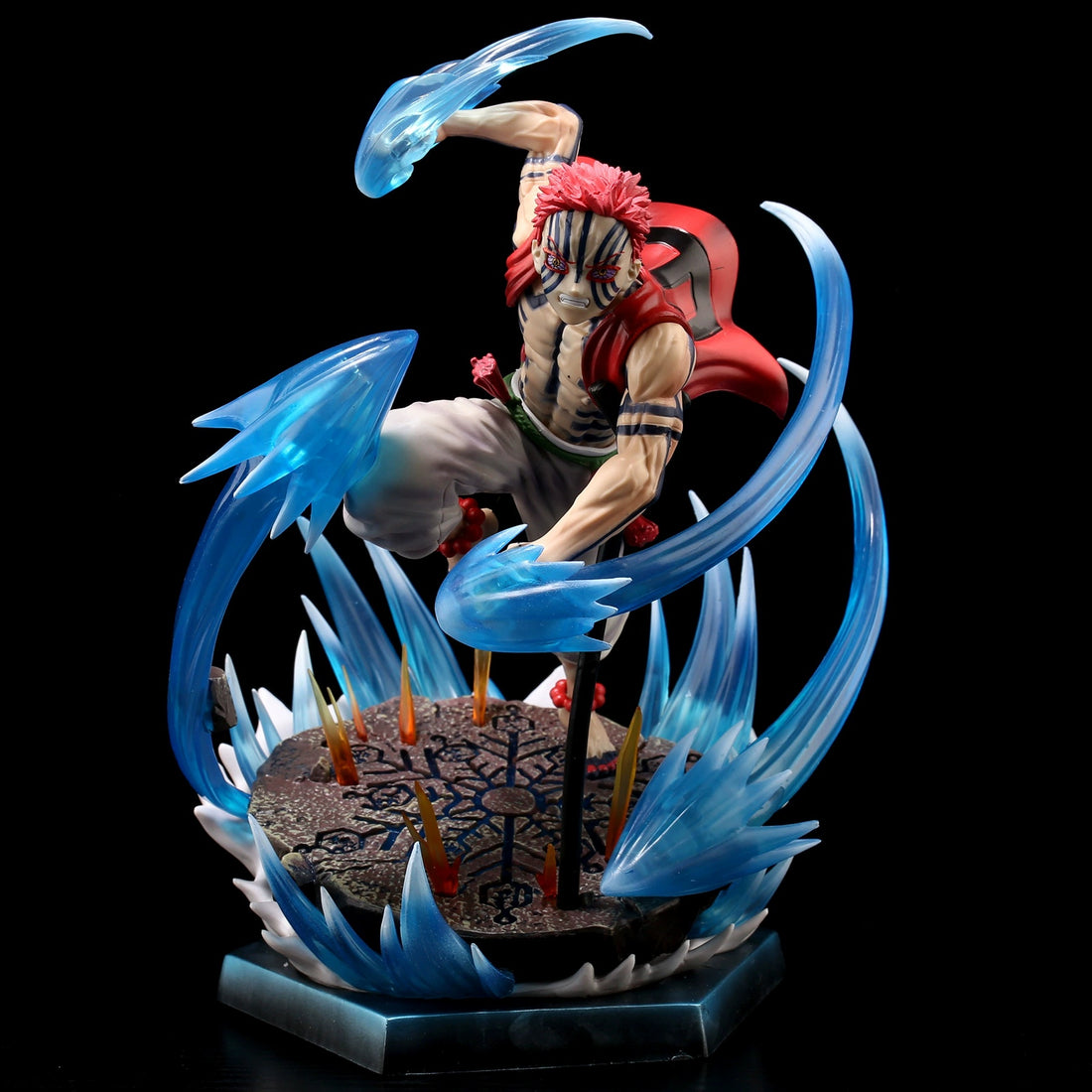 The Rengoku Kyojuro Demon Slayer Figure, a 26cm PVC collectible by Demon Slayer, depicts the red spiky-haired character mid-air in red cloak and striped pants. Surrounded by blue energy spikes on a textured base, it features dynamic ice powers and light-up effects.