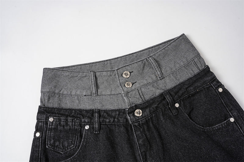 Close-up of black jeans front waistband with gray double-layer waist and metal buttons