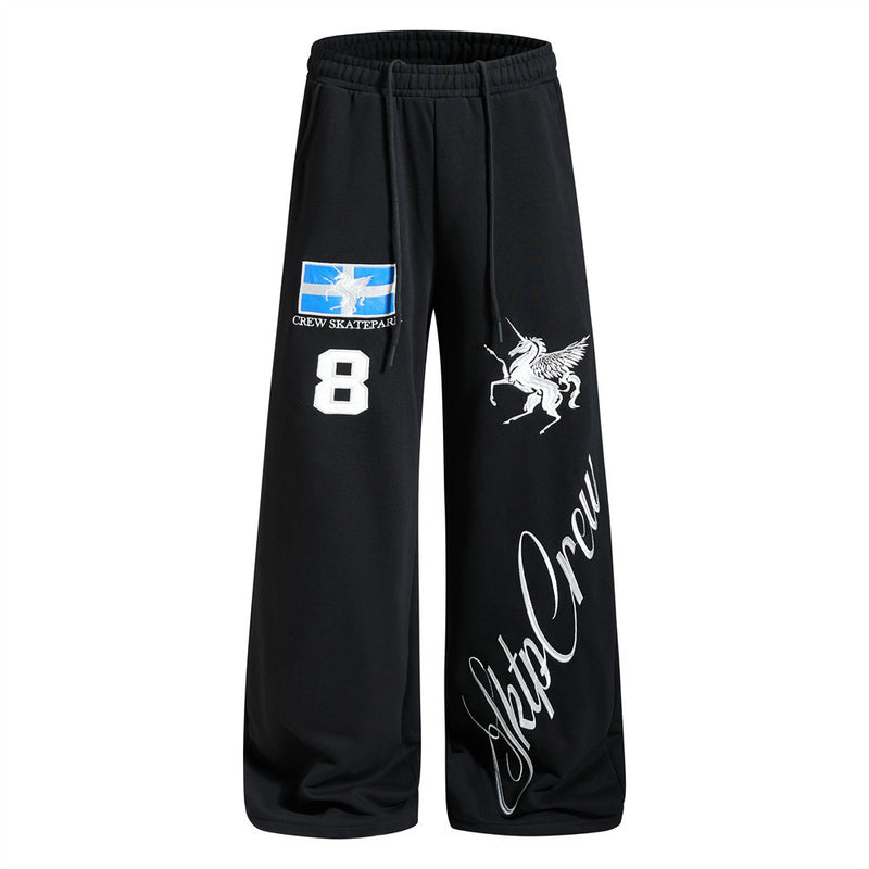 Black wide-leg sweatpants with embroidered Pegasus, Crew Skatepark flag patch, number 8 appliqué, and Sktp Crew script graphi