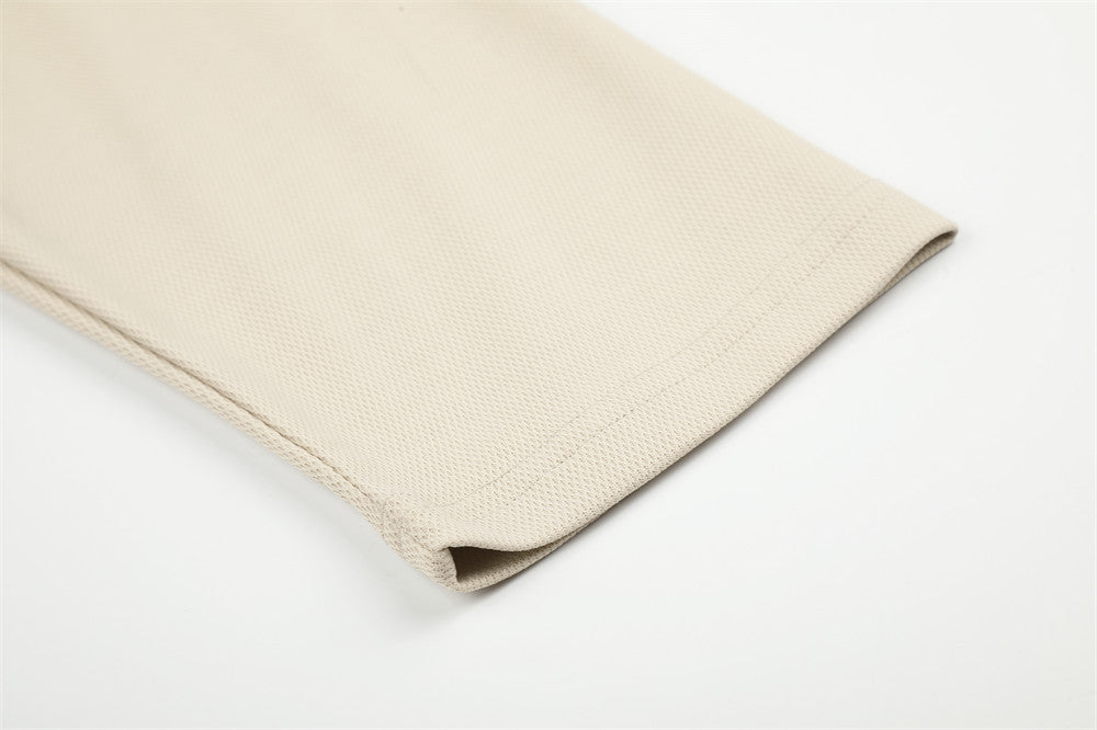 Beige sleeve cuff detail with straight hem and textured fabric