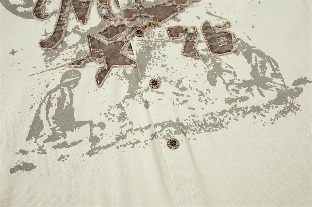 Front lower chest detail of cream shirt with faded vintage print and button placket