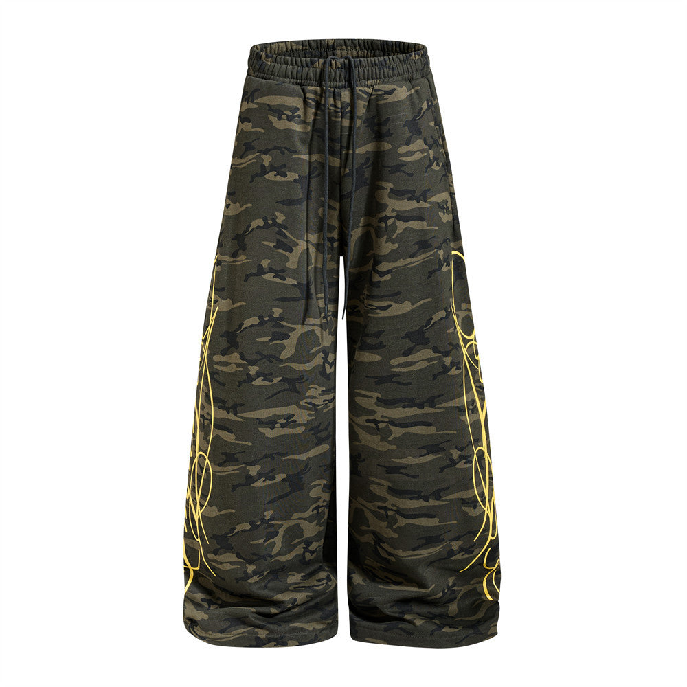 Men's oversized wide-leg camouflage sweatpants with yellow graffiti line art print on outer legs and drawstring waist