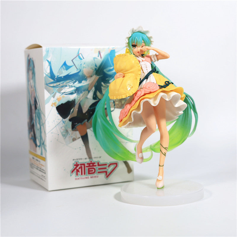 The Fairy Tale Sleeping Beauty Hatsune Miku 19cm PVC Figure features a charming design with long green hair, a colorful dress, and a round base. She holds a yellow object cheerfully. The collectible is boxed with matching artwork, ideal for Vocaloid fans.