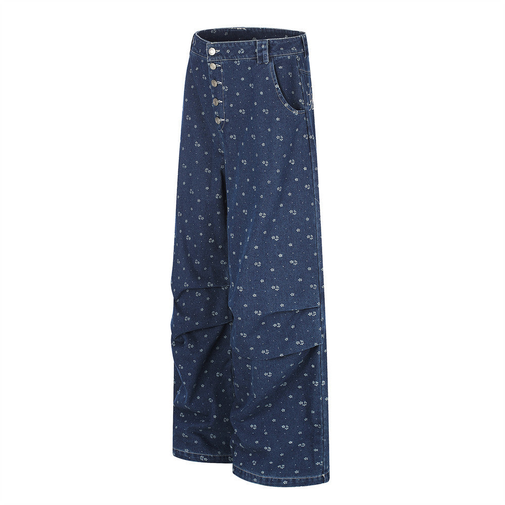 Side view of dark blue wide-leg jeans with floral print and layered knee seams